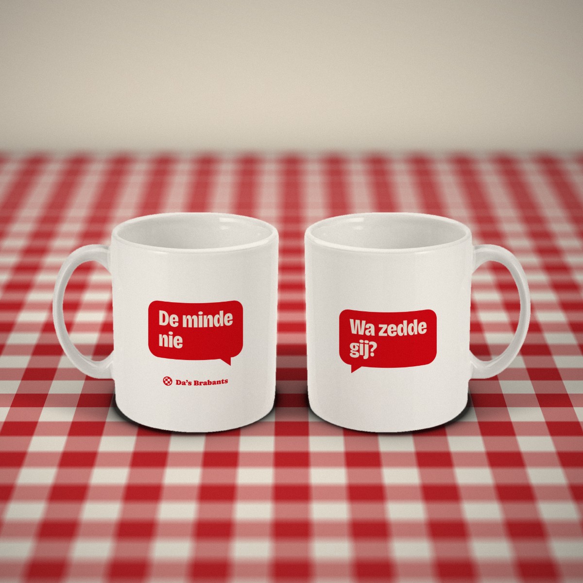 Voor- en achterkant: twee witte mokken met tekstballonnetjes naast elkaar op een rood-wit geruit tafelkleed